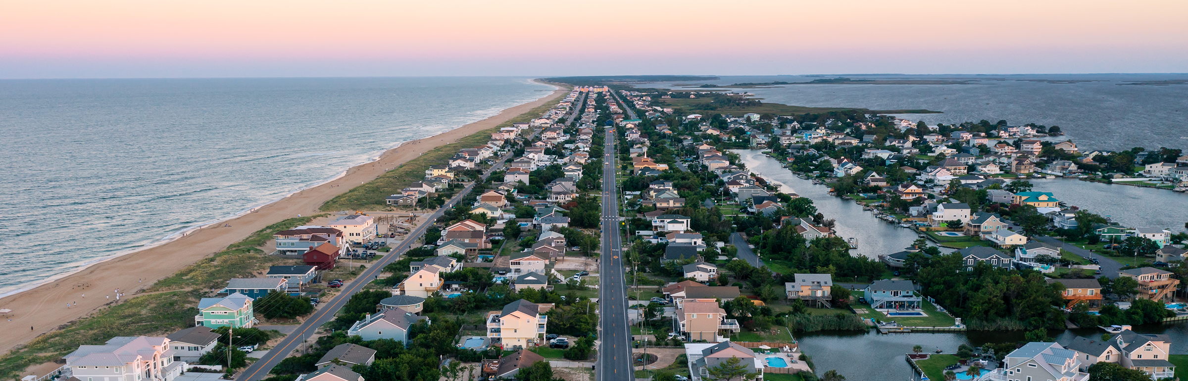 Aerial photo of houses and roads along the ocean