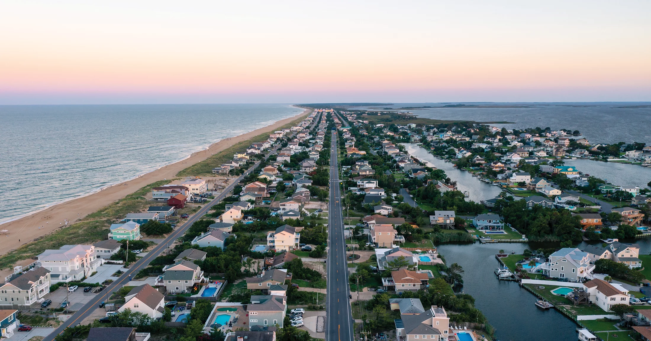 Aerial photo of house and beach at sunset