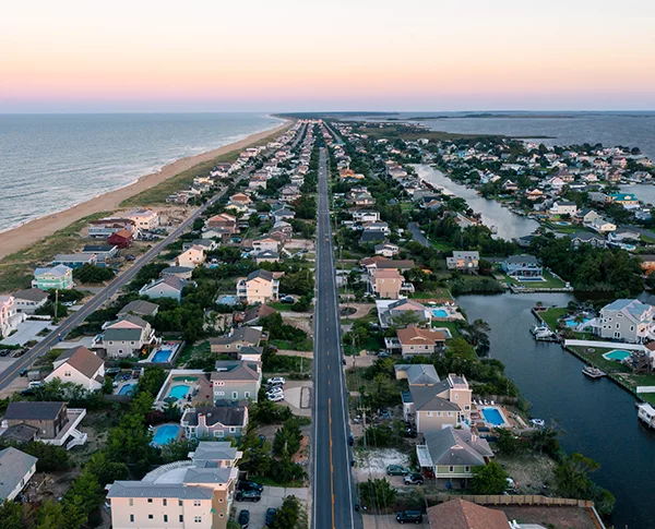 Aerial photo of house and beach at sunset