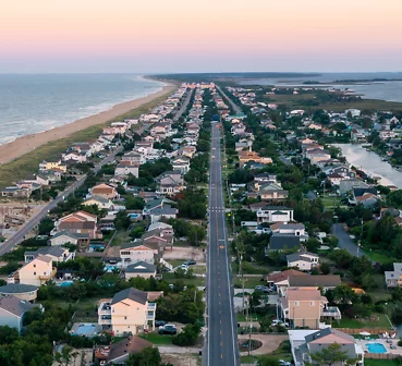 Aerial photo of houses and roads along the ocean